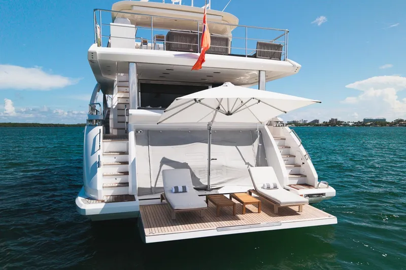 Slide: The Image of Luxury Azimut Grande 27 METRI yacht, 2022 model, with sun loungers and umbrella on deck. - 12