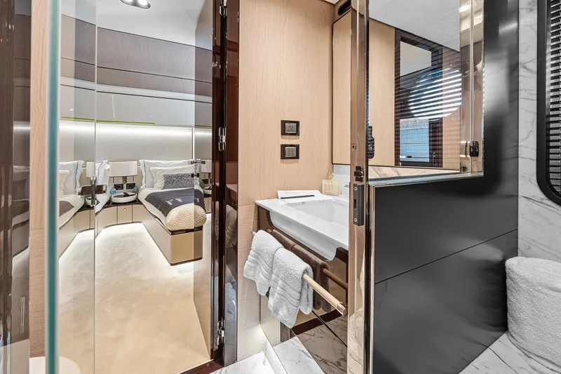 Slide: The Image of Luxurious interior of 2022 Azimut Grande 27 METRI yacht, featuring elegant bedroom and bathroom. - 120