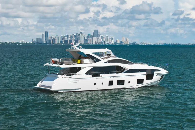 Slide: The Image of Luxury Azimut Grande 27 METRI yacht cruising near city skyline, 2022 model. - 13