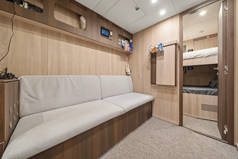 Slide: The Image of Interior of 2022 Azimut Grande 27 METRI yacht with modern wood paneling and cozy seating. - 138