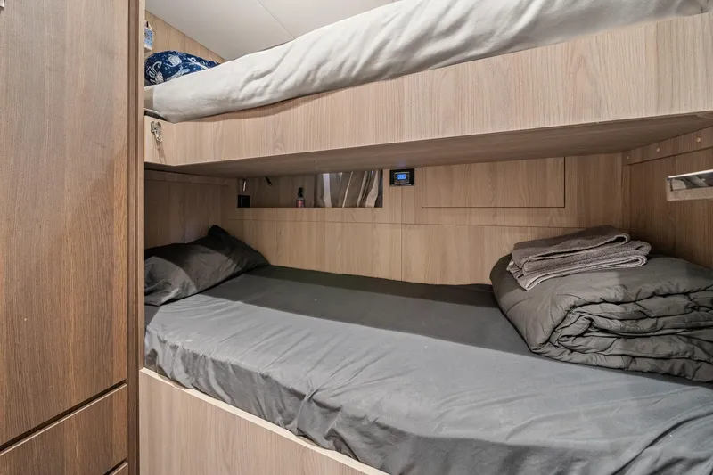 Slide: The Image of Bunk beds in 2022 Azimut Grande 27 METRI yacht cabin with wood paneling. - 141