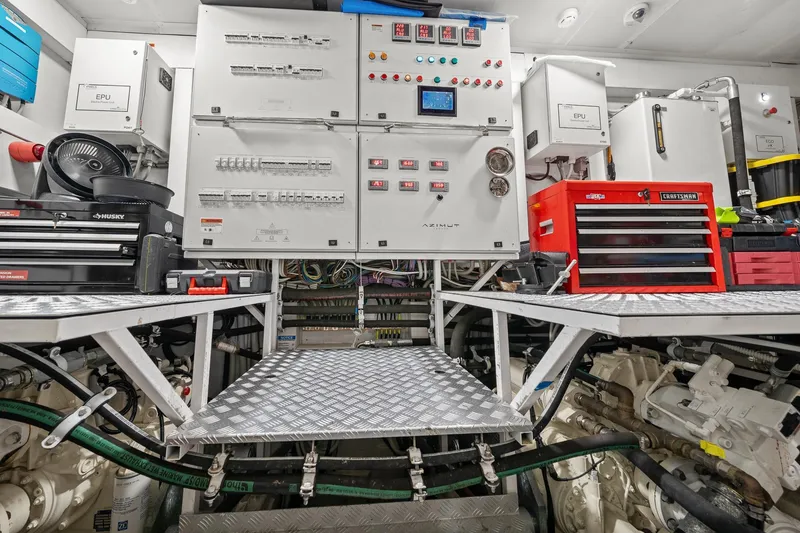 Slide: The Image of Engine room of 2022 Azimut Grande 27 METRI yacht with control panels and toolboxes. - 142