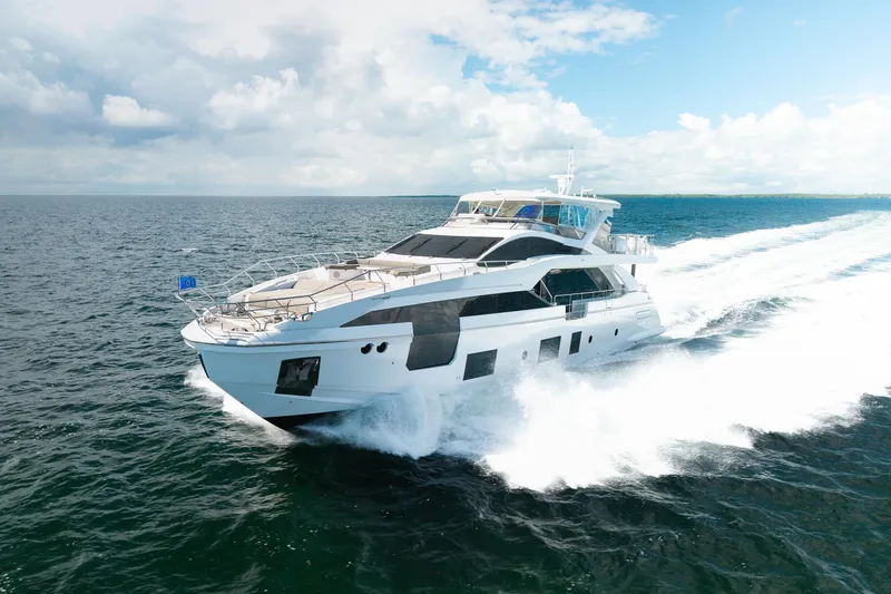 Slide: The Image of Luxurious 2022 Azimut Grande 27 METRI yacht cruising on open sea under clear skies. - 20