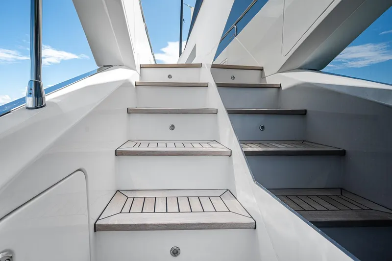 Slide: The Image of Staircase on 2022 Azimut Grande 27 METRI yacht under clear blue sky. - 38