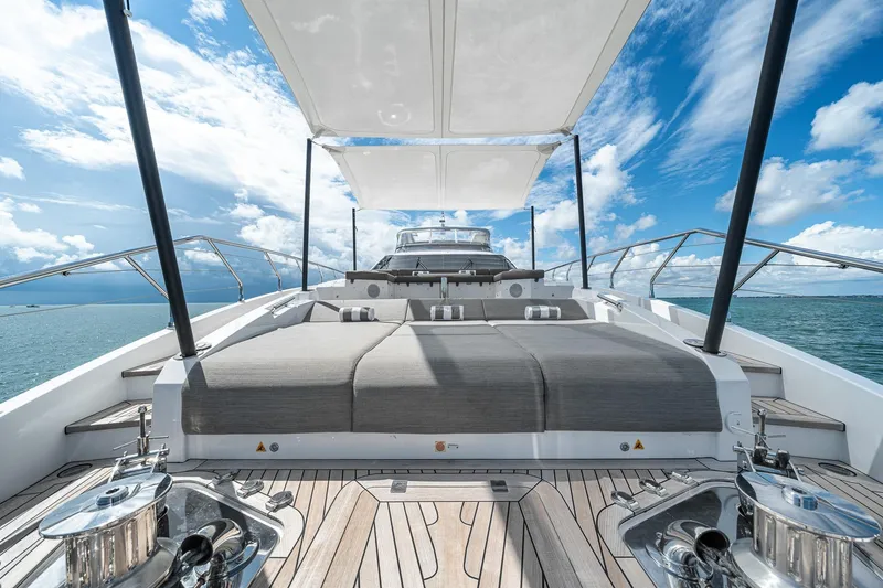Slide: The Image of Luxurious Azimut Grande 27 METRI yacht deck with sunbeds, 2022 model, under a clear blue sky. - 42
