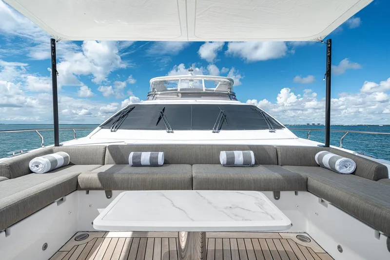 Slide: The Image of Luxurious 2022 Azimut Grande 27 METRI yacht deck with seating, ocean view, and blue sky. - 44