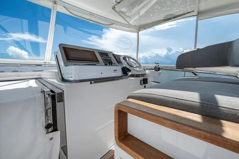 Slide: The Image of Cockpit of 2022 Azimut Grande 27 METRI yacht with modern controls and seating. - 58