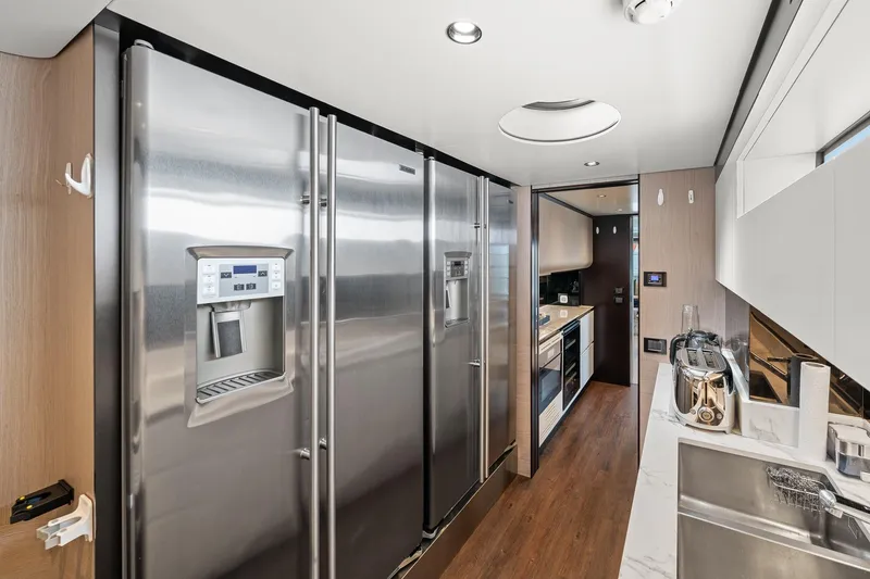 Slide: The Image of Modern kitchen interior on 2022 Azimut Grande 27 METRI yacht, featuring stainless steel appliances. - 69