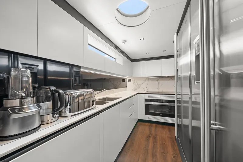 Slide: The Image of Modern kitchen interior on 2022 Azimut Grande 27 METRI yacht, featuring sleek appliances and elegant design. - 71