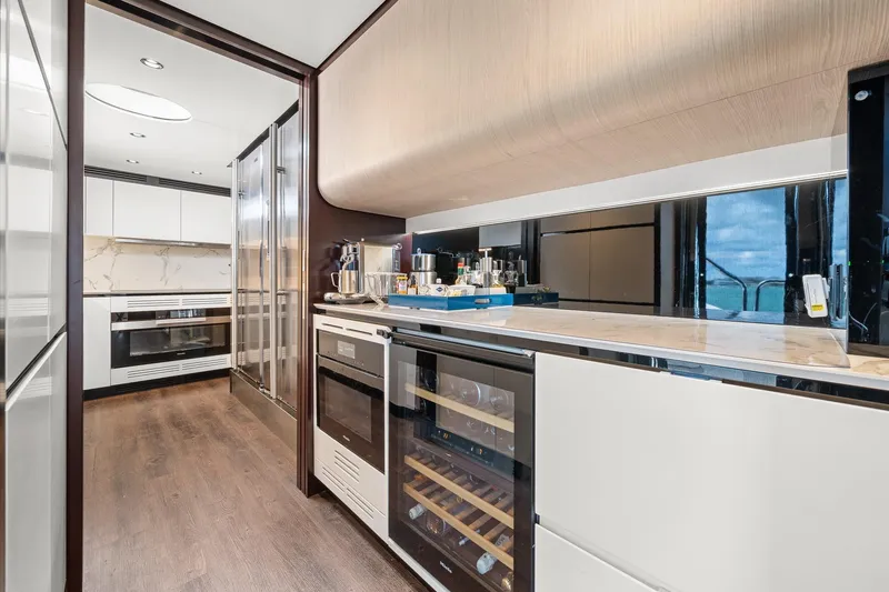 Slide: The Image of Luxurious kitchen interior of 2022 Azimut Grande 27 METRI yacht, featuring modern appliances. - 73
