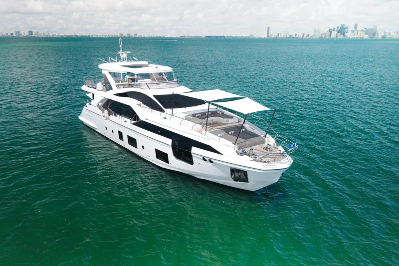 Slide: The Image of Luxurious 2022 Azimut Grande 27 METRI yacht cruising on clear blue waters. - 9