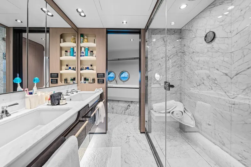 Slide: The Image of Luxurious bathroom in 2022 Azimut Grande 27 METRI yacht with marble finishes and dual sinks. - 99