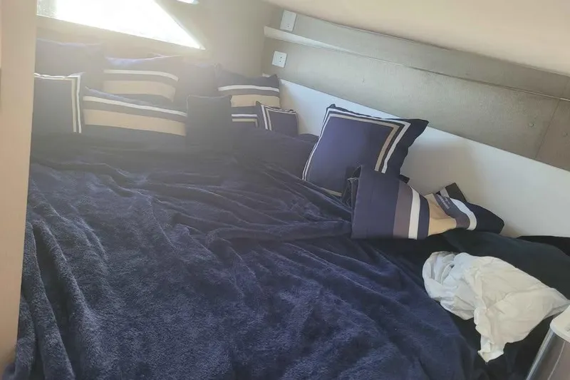 Slide: The Image of Luxurious bed with navy and striped pillows in 2024 Hanover 387 interior. - 10