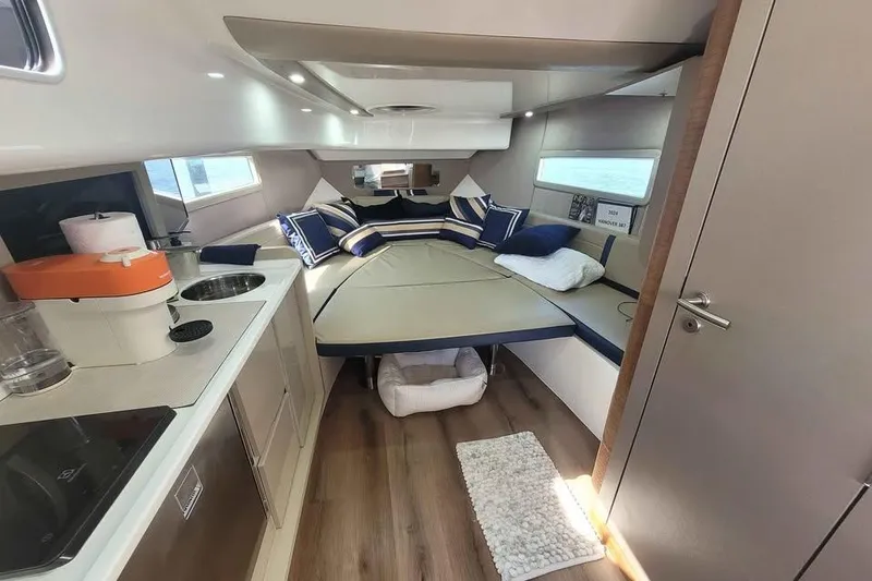 Slide: The Image of Luxurious interior of 2024 Hanover 387 yacht with cozy bed and modern kitchenette. - 11
