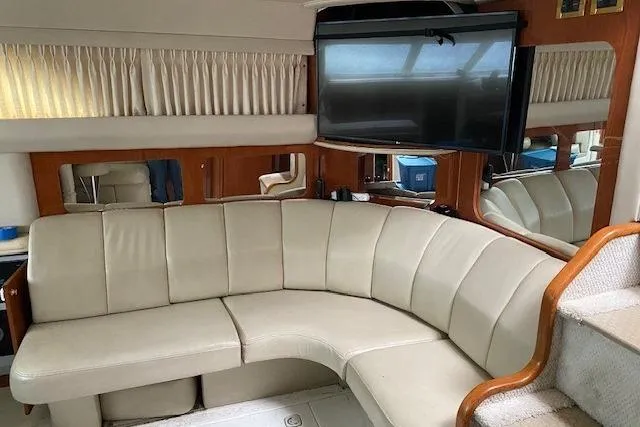Slide: The Image of Luxurious interior of 1999 Sea Ray 420 Aft Cabin with leather seating and TV. - 11