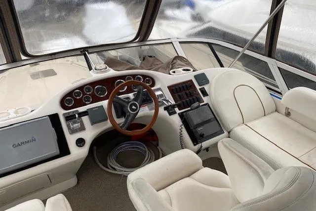 Slide: The Image of 1999 Sea Ray 420 Aft Cabin helm with Garmin navigation and luxurious seating. - 3