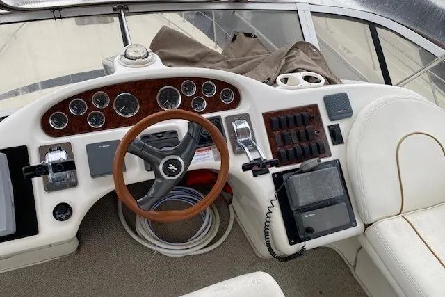 Slide: The Image of Cockpit of 1999 Sea Ray 420 Aft Cabin with steering wheel and control panel. - 6