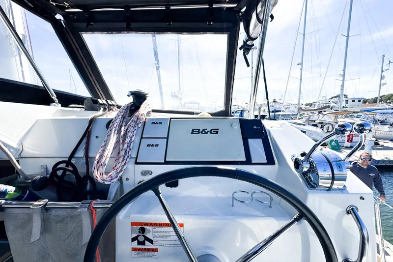 Slide: The Image of Cockpit view of 2018 Lagoon 40 catamaran with steering wheel and navigation equipment. - 11