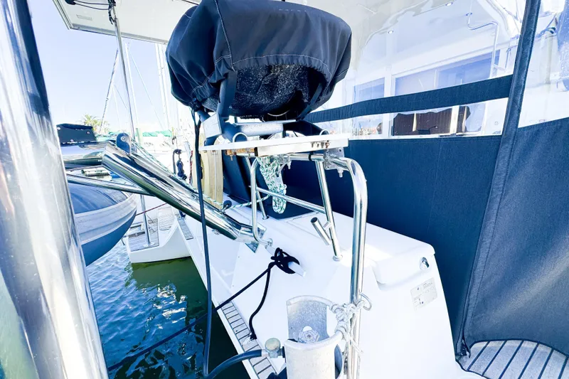 Slide: The Image of 2018 Lagoon 40 yacht stern view with covered equipment and marina backdrop. - 14