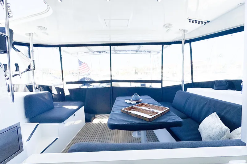 Slide: The Image of Spacious interior of 2018 Lagoon 40 catamaran with comfortable seating and table setup. - 17