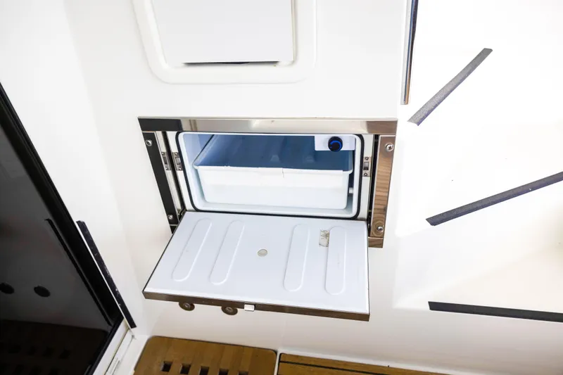 Slide: The Image of Built-in refrigerator on 2018 Lagoon 40 catamaran, open with visible storage compartment. - 19