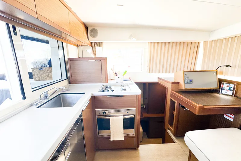 Slide: The Image of Interior of 2018 Lagoon 40 yacht featuring modern kitchen and navigation area. - 28