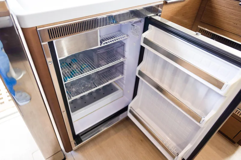 Slide: The Image of Open refrigerator inside 2018 Lagoon 40 yacht, showcasing organized shelves and modern design. - 32