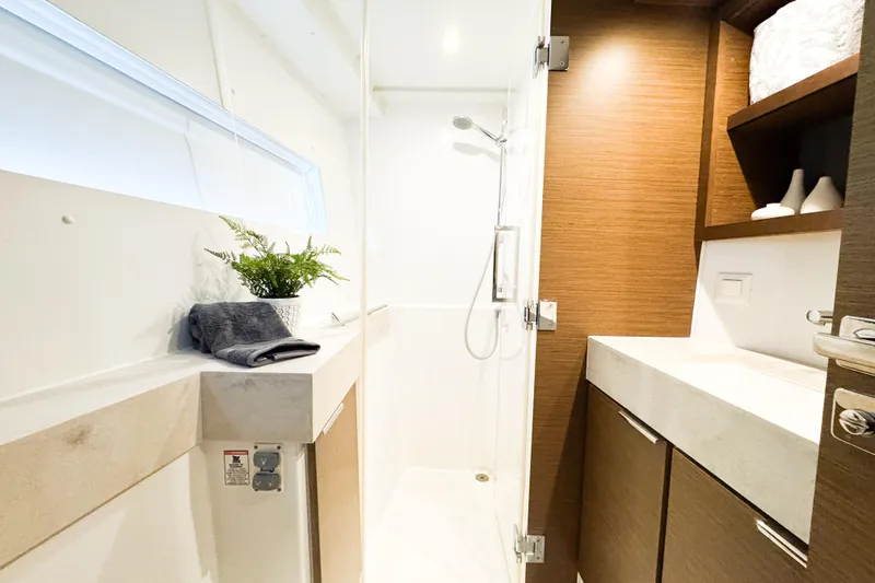 Slide: The Image of Modern bathroom interior of 2018 Lagoon 40 yacht with shower and wooden cabinetry. - 39
