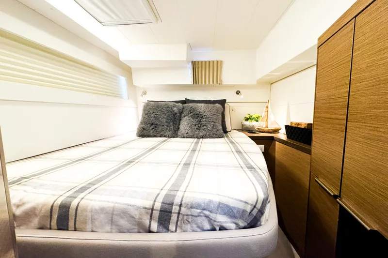 Slide: The Image of Cozy bedroom interior of 2018 Lagoon 40 yacht with plush bedding and wooden cabinetry. - 42