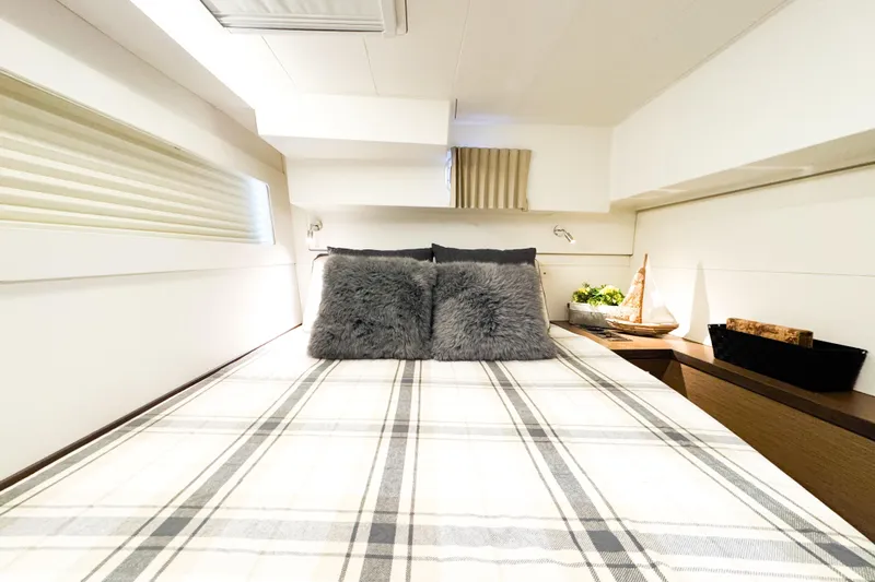 Slide: The Image of Luxurious cabin interior of 2018 Lagoon 40 catamaran with cozy bedding and modern decor. - 43