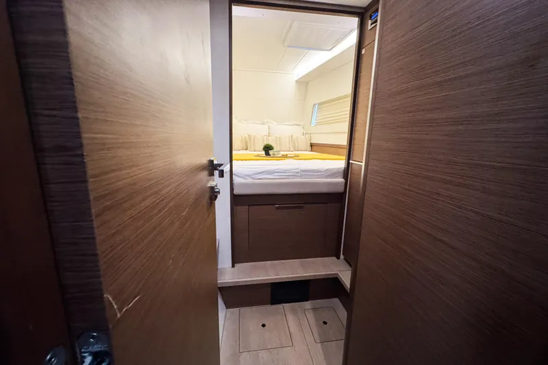 Slide: The Image of Interior cabin of 2018 Lagoon 40 catamaran with cozy bed and wooden finish. - 46