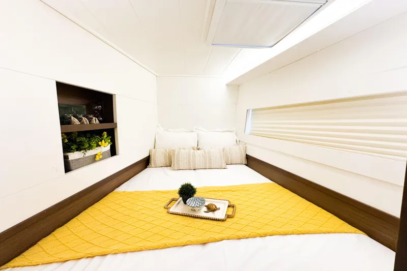 Slide: The Image of Cozy bedroom interior of 2018 Lagoon 40 yacht with yellow accents and decorative plants. - 47