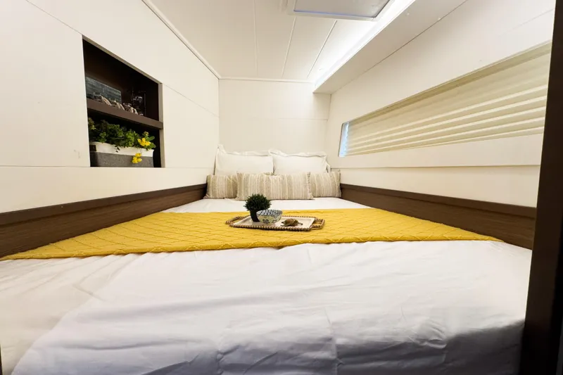 Slide: The Image of Luxurious cabin interior of 2018 Lagoon 40 catamaran with cozy bedding and decor. - 48