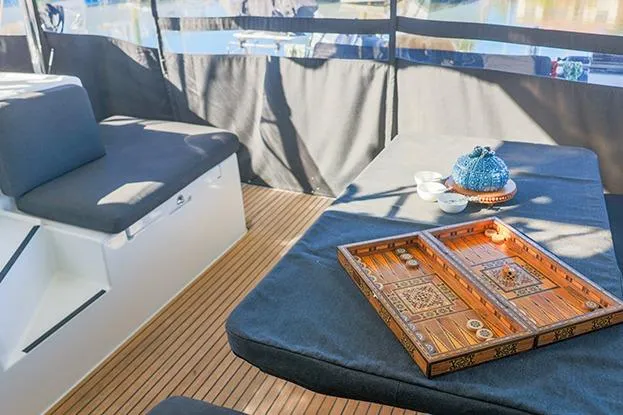 Slide: The Image of Cozy seating area on 2018 Lagoon 40 catamaran with backgammon set and teapot. - 52