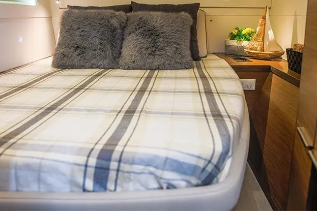 Slide: The Image of Cozy bedroom in 2018 Lagoon 40 yacht with plaid bedding and plush pillows. - 54