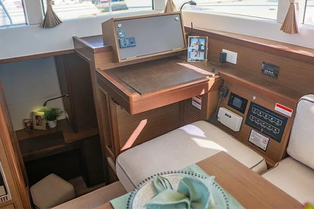Slide: The Image of Interior of 2018 Lagoon 40 catamaran with navigation station and cozy seating area. - 55