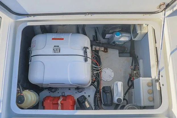Slide: The Image of Engine compartment of 2018 Lagoon 40 catamaran with various mechanical components and storage. - 56