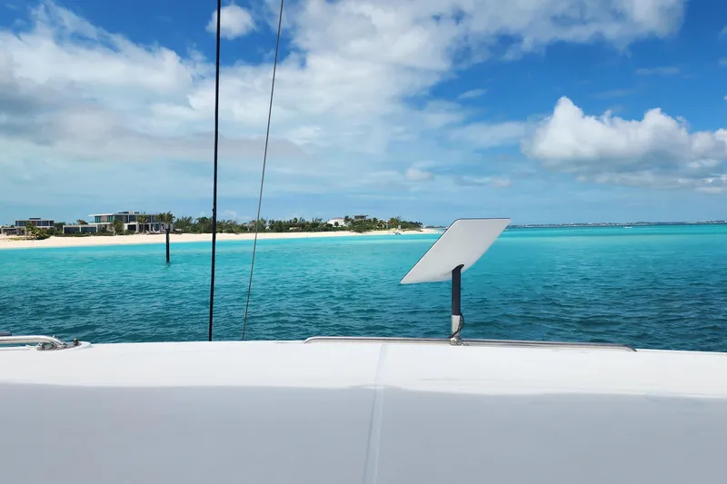 Slide: The Image of Lagoon 40 catamaran sailing near tropical beach, turquoise waters, clear blue sky, 2018 model. - 6