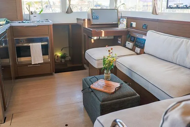 Slide: The Image of Interior of 2018 Lagoon 40 catamaran with cozy seating and modern kitchen amenities. - 62