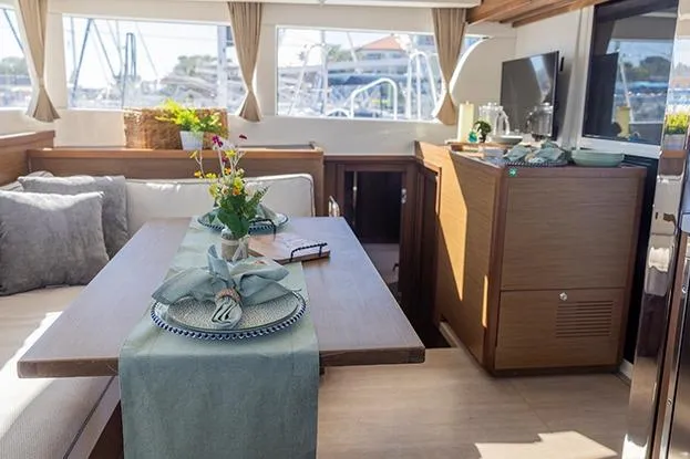 Slide: The Image of Interior of 2018 Lagoon 40 catamaran with elegant dining setup and modern decor. - 63