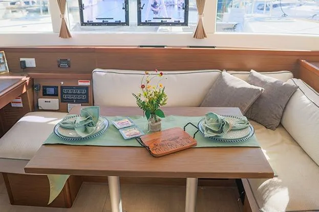 Slide: The Image of Interior of 2018 Lagoon 40 catamaran with elegant dining setup and cozy seating. - 68