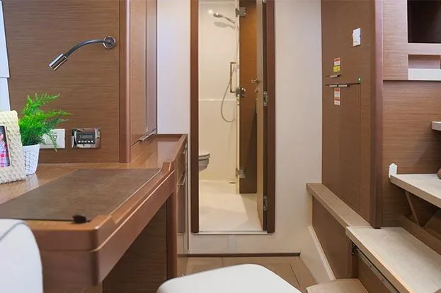 Slide: The Image of Interior of 2018 Lagoon 40 yacht, featuring a modern bathroom and wooden furnishings. - 75