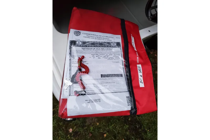 Slide: The Image of Red bag with boat title and keys for 2020 Boston Whaler 130 Super Sport. - 13