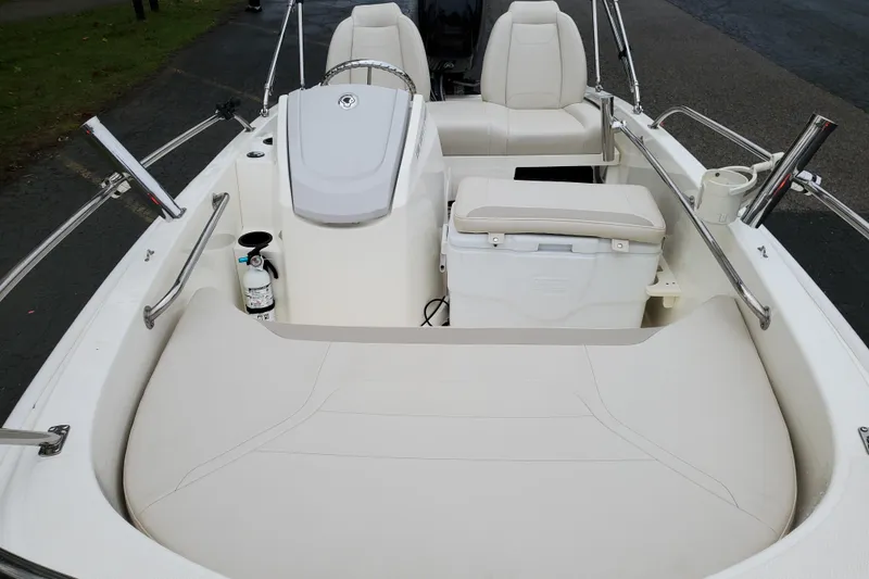 Slide: The Image of 2020 Boston Whaler 130 Super Sport interior with seating and storage features. - 7