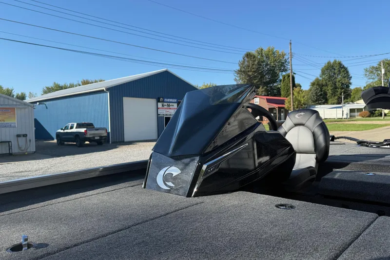 Slide: The Image of 2026 Crestliner XF189 boat interior with steering wheel and seat, parked near blue building. - 14