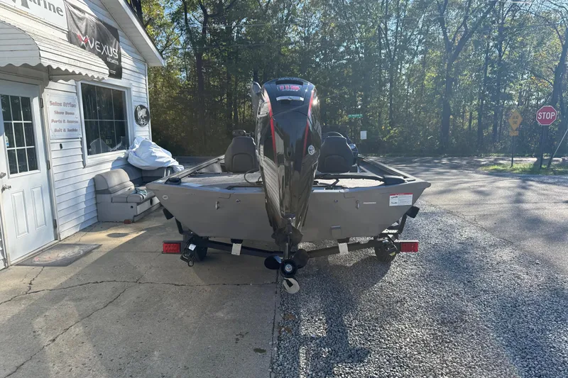 Slide: The Image of 2026 Crestliner XF189 boat on trailer outside a marine shop. - 4