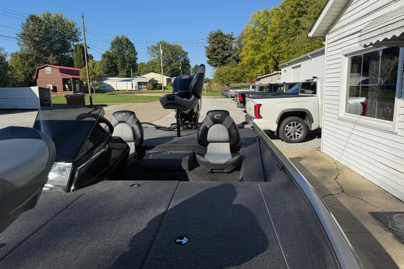 Slide: The Image of 2026 Crestliner XF189 boat with seating, parked outdoors near buildings and vehicles. - 8