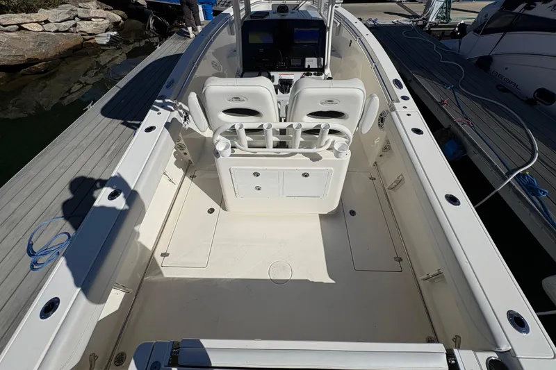 Slide: The Image of 2022 Cobia 280 Center Console boat interior with seating and control panel. - 11