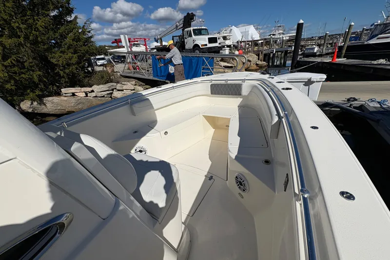 Slide: The Image of 2022 Cobia 280 Center Console boat docked, showcasing spacious seating and sleek design. - 18