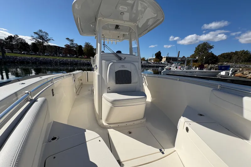 Slide: The Image of 2022 Cobia 280 Center Console boat docked, showcasing spacious seating and helm. - 19